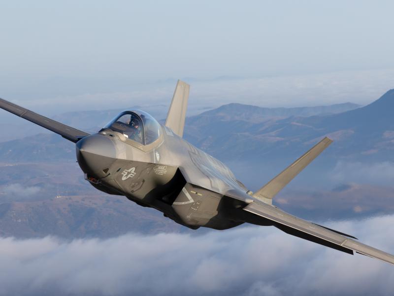 Very close top view of a F-35C Lightning II over clouds