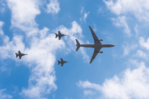 KC-135 aerial refueling tanker aircraft flying over clouds during a training mission