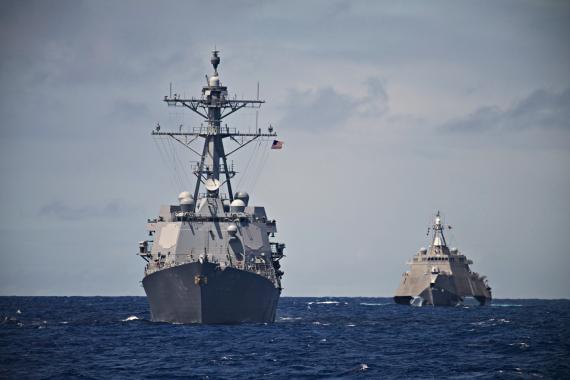 A USS Destroyer and Littoral Combat Ship hunt together in the South Pacific