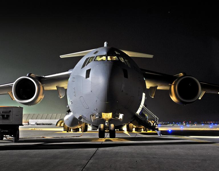 Military cargo aircraft at night, highlighting contested logistics and the role of logistics simulation software and modeling in mission sustainment