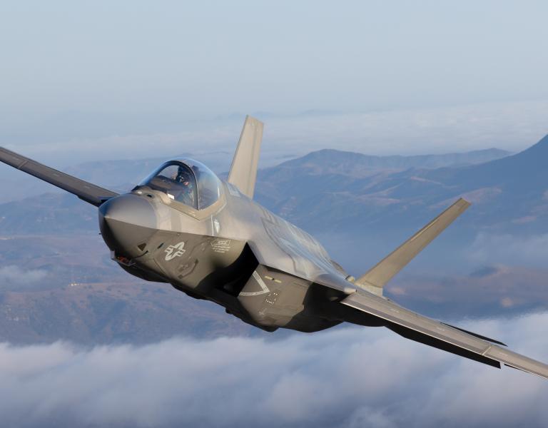 Very close top view of a F-35C Lightning II over clouds
